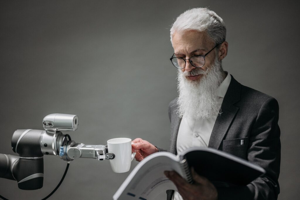 Man Reading Notes and Holding a Cup from a Robotic Arm